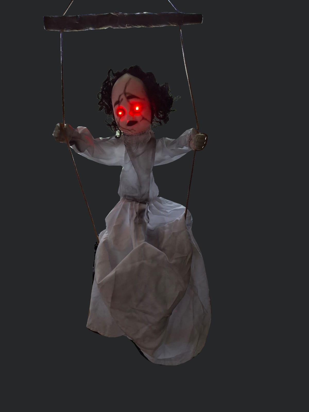 Background-cleaned actual photograph of Swing by After Dark with red eyes illuminated. Doll and captured glow preserved; original room background removed.
