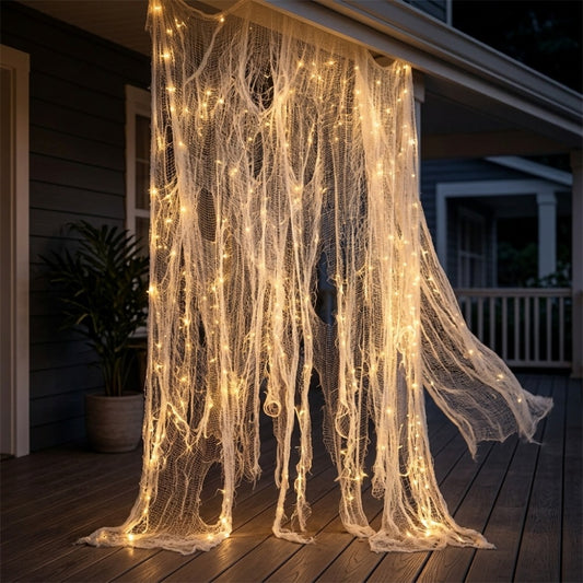 Lighted torn white Halloween gauze curtain with warm LED string lights