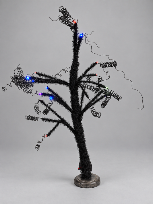 Black glitter tree with multicolour LED lights, photographed from actual stock; background and lighting retouched