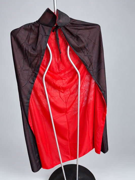 Retouched actual stock photo of the red-and-black reversible cape; display stand not included