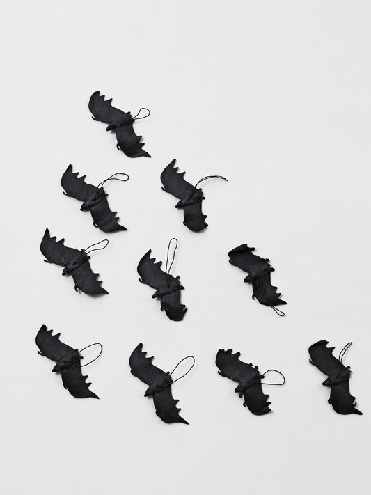 Retouched actual stock photo of ten black rubber bats with hanging loops and curled wings