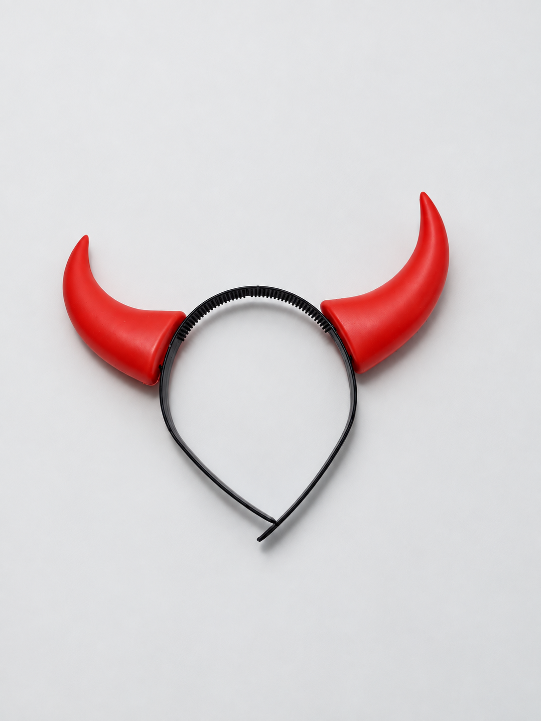 Retouched actual stock photo of one red devil-horns headband with a black band