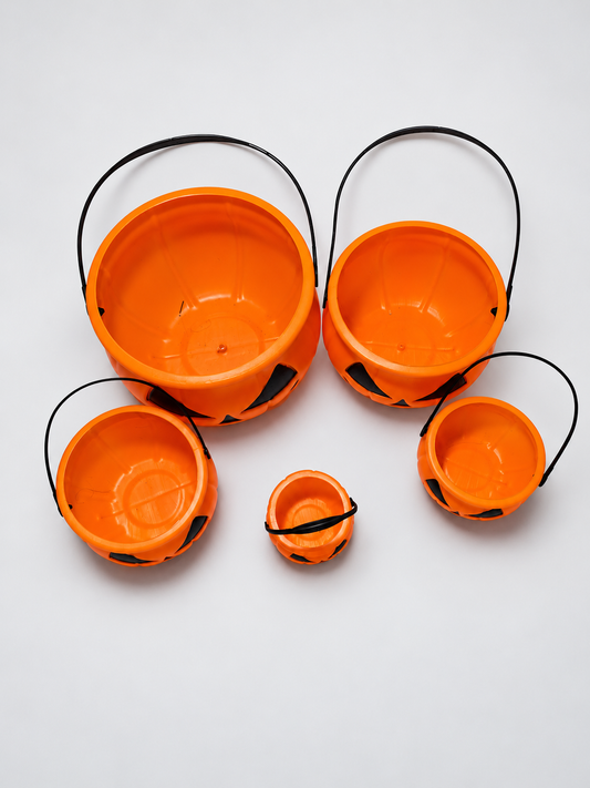 Retouched actual stock photo of five orange pumpkin buckets in different sizes with black handles
