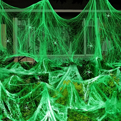 Illustrative green glow-effect stretch-web styling display. Decorative spiders and other background props illustrate styling; the item sold is one web pack.