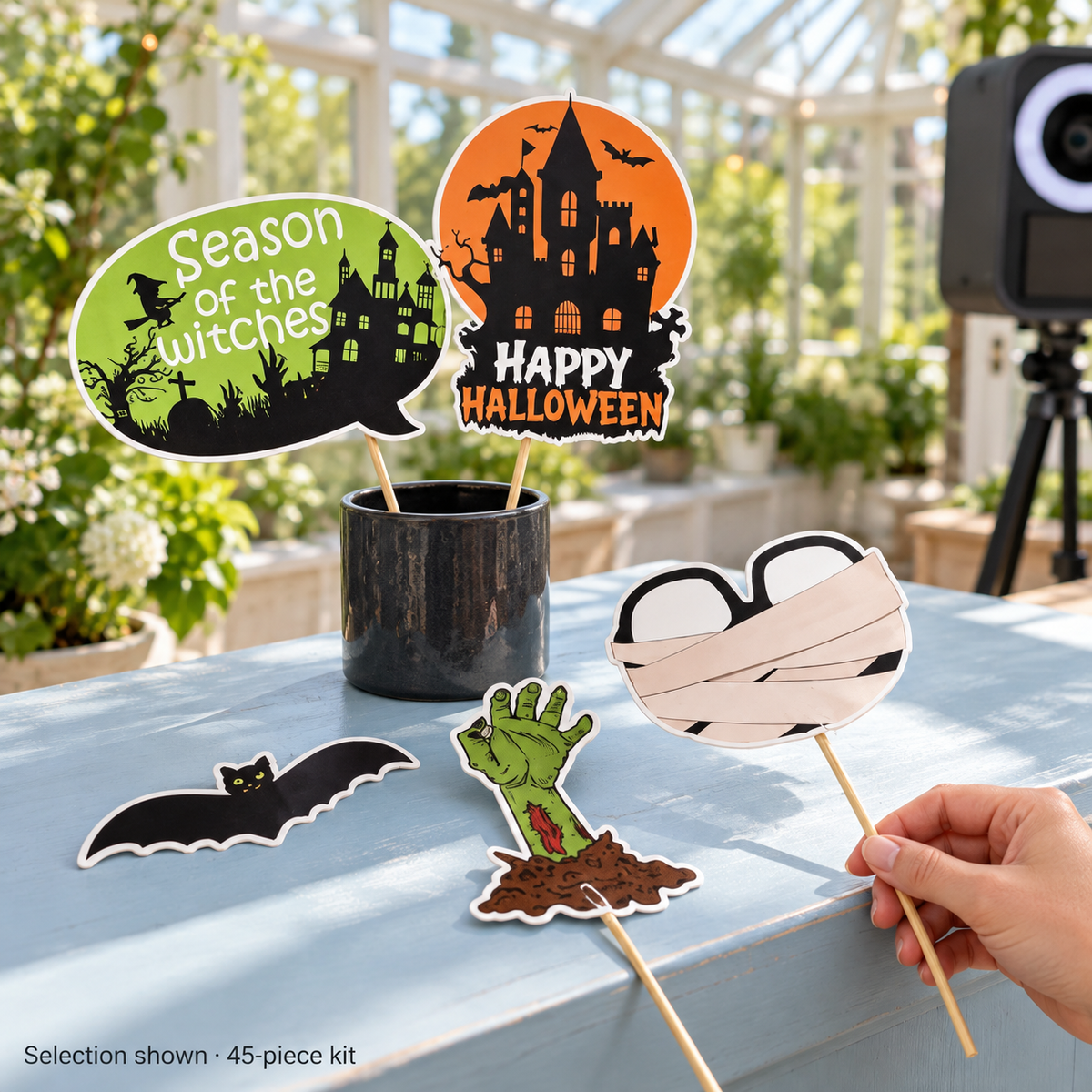Boos & Poses selected Halloween props at a daylight prop station; 45-piece kit, holder and camera not included.