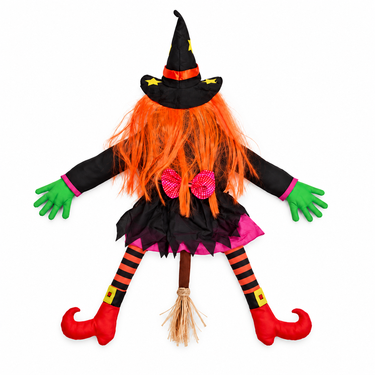 One orange-haired tree-crash witch decoration laid out on white with its hands, boots and broom.