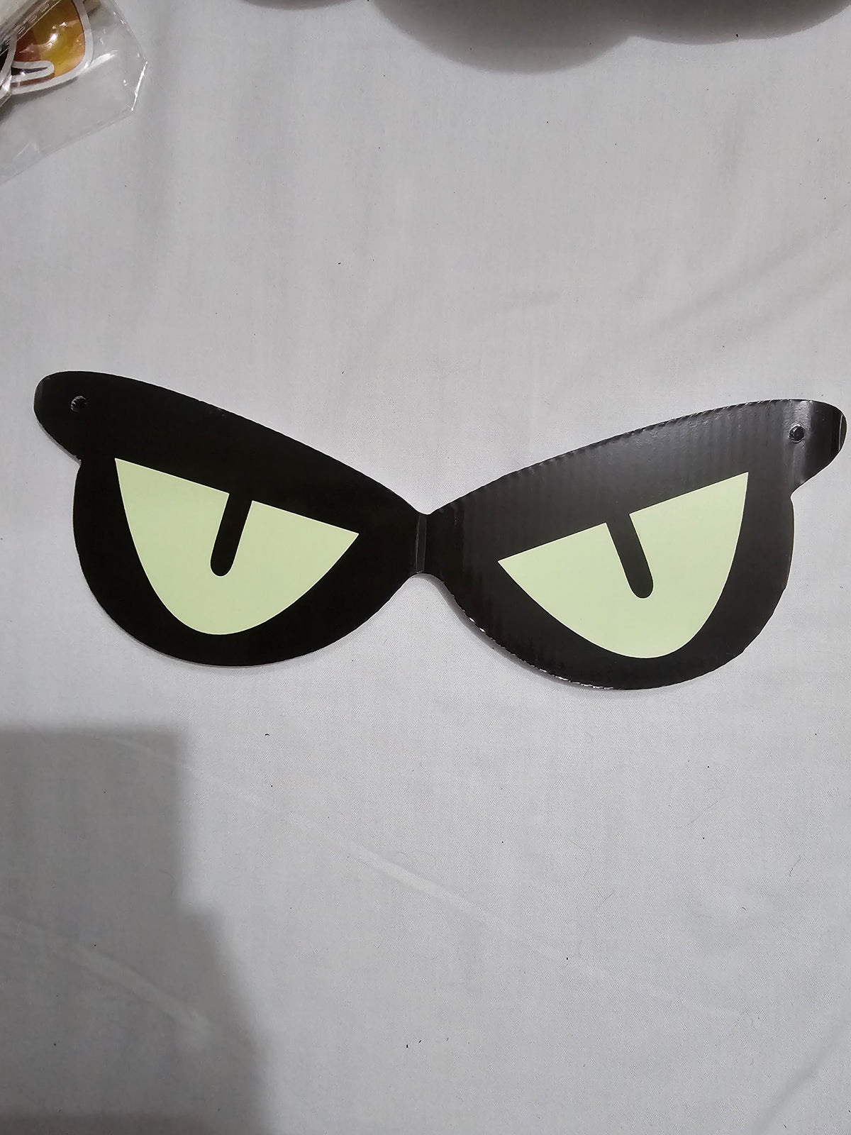 Unedited actual-stock daylight photograph of one assembled Somebody’s Watching eye decoration; the sale set contains four decorations. Original surface, folds and colour retained.