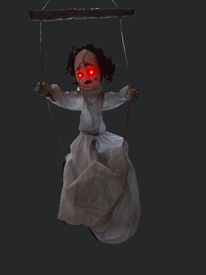 Background-cleaned actual photograph of Swing by After Dark with red eyes illuminated. Doll and captured glow preserved; original room background removed.